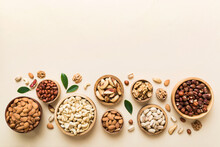Mixed Nuts In Wooden Bowl. Mix Of Various Nuts On Colored Background. Pistachios, Cashews, Walnuts, Hazelnuts, Peanuts And Brazil Nuts