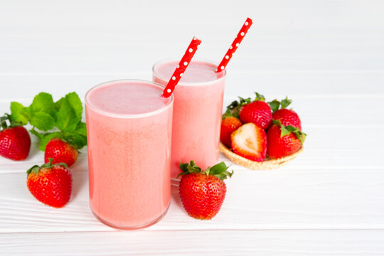 Fototapete - Strawberry yogurt fruit juice smoothie pink colorful fruit juice milkshake blend beverage healthy high protein the taste yummy In glass drink episode morning on white wood background.