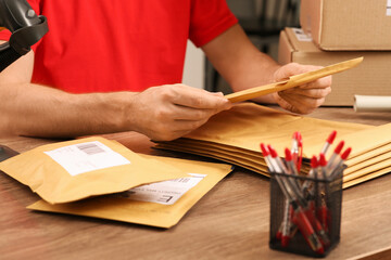 Wall Mural - Post office worker with adhesive paper bags at counter indoors, closeup