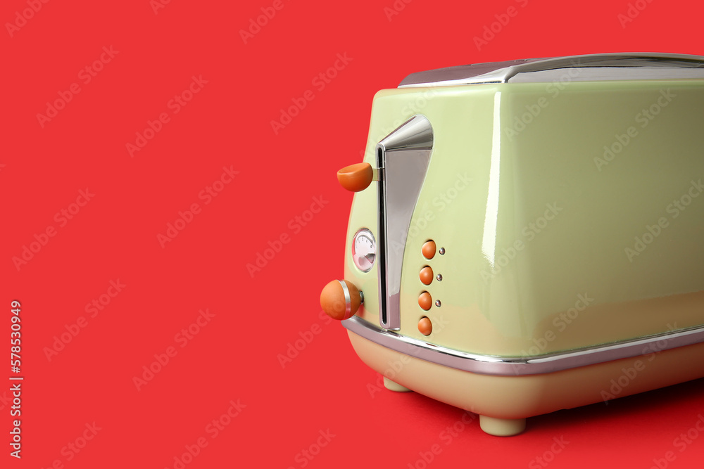 Modern toaster on red background