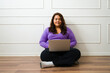 © AntonioDiaz - Obese young woman working from home on the laptop
