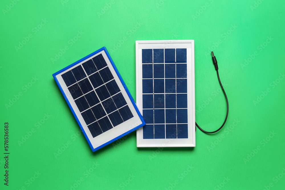 Portable solar panels on green background