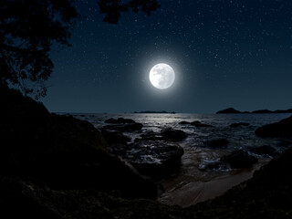 full moon over the sea with stars