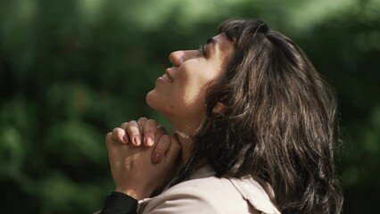 Wall Mural - Profile of South American person praying to God. A grateful hispanic woman in prayer feeling gratitude and grace