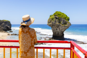 Wall Mural - Travel woman go Liuqiu Island Flower Vase Rock in Taiwan