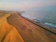 Aerial top view of street road with Namib Desert Safari, sand dune, coast sea in Namibia, South Africa. Natural landscape background at sunset. Famous tourist attraction. Sand in Grand Canyon