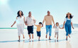 © Anela R/peopleimages.com - Portrait, family holding hands and walking on beach, quality time and bonding together. Face, parents and children with grandchildren, seaside vacation and holiday with happiness, love and traveling