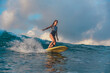 © Cavan Images - Female surfer on a wave