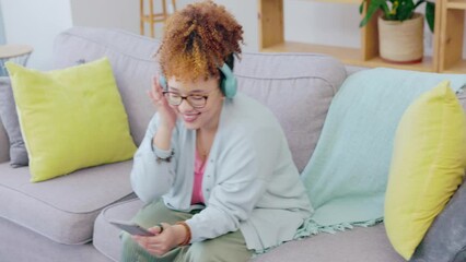 Canvas Print - Black woman, music headphones and dancing on couch with smile, happiness and relax in home living room. Gen z girl, streaming and audio electronics for radio, dance and happy for song on internet app