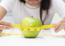Slim Food Concept Women Weight Loss Measure Green Apple By Tape