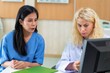 © Tongpool - Young female doctor discus with lady patient on healthy problem at hospital clinic