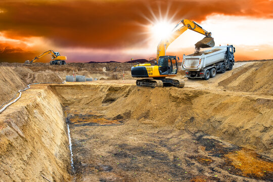 Fototapete -  excavator is working and digging at construction site