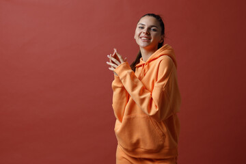 Wall Mural - Young positive smiling woman in orange fitness sport outfit cloth dancing.