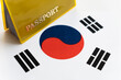 Flag of south korea with passport. Travel visa and citizenship concept. residence permit in the country. a yellow document with the inscription passport is on flag. Close up, top view