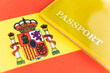 Flag of spain with passport. Travel visa and citizenship concept. residence permit in the country. a yellow document with the inscription passport is on flag. Close up, top view