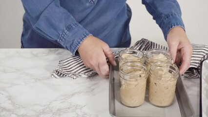 Wall Mural - Step by step. Scooping homemade chocolate ice cream into glass jars.