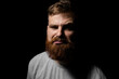 © Volodymyr - Close-up portrait of a handsome a brunette brutal bearded man in a grey t-shirt. Stylish and handsome man with a beard.