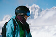 © Annatamila - Close up portrait of Snowboarder woman standing with mountain peaks covered with snow on background