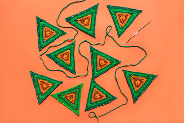 Wall Mural - Top view on green crochet motifs of triangle form,  green croche