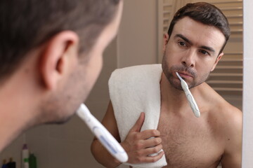 Wall Mural - Shirtless man washing his teeth