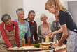 © Cameron M/peopleimages.com - Getting the pasta dish rolling. a woman showing her class how to make pasta.