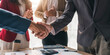 © wichayada - Business people shaking hands, finishing up meeting, business etiquette, congratulation, merger and acquisition concept.