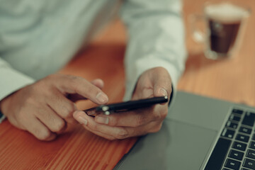 Poster - Casual businessman works from home using laptop, smartphone with coffee. Student reads e-book, studies online course via smartphone app.