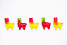 Jelly Marmalade Candies In The Form Of Llamas On A White Background. Colorful Sweet Confectionery On An Isolated White Background. Multicolored Jelly Candies Lined Up In A Row