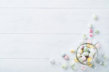 Wall Mural - Sweet Easter concept. Sweet Easter kids holiday assortment marshmallows rabbit, chocolates easter eggs, candies, bunny, snacks  on white wooden background. Flat lay Easter decoration idea. Mock up.