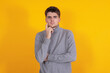 © carballo - young man isolated on yellow background
