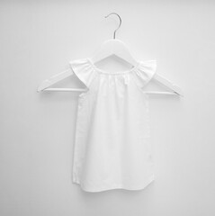 Wall Mural - Mockup of white baby cotton dress on white background. Layout mock up ready for your design preview. Dress on a white hanger