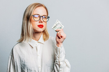 Sticker - Portrait of beautiful blonde in white shirt with money on white background