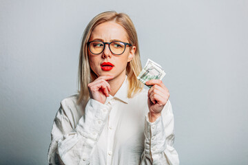 Sticker - Portrait of beautiful blonde in white shirt with money on white background