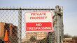 © Your Hand Please - No Trespass sign in front of private property depicting security, privacy, and protection