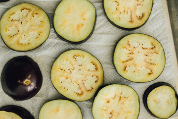 Wall Mural - sliced eggplant aubergine rings, washed and drying on paper towel