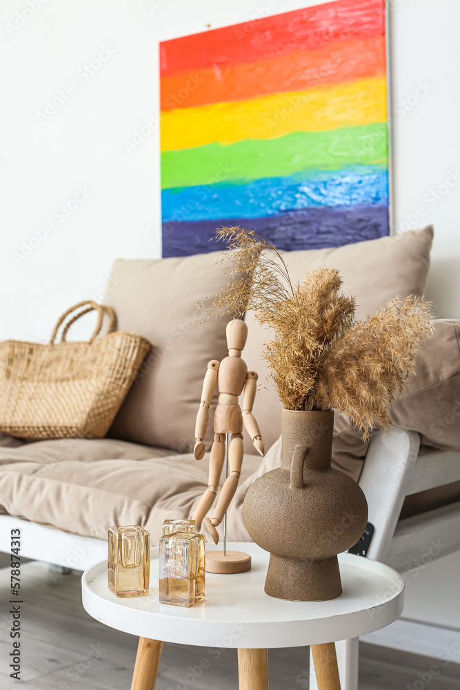 Vase with pampas grass and mannequin on table in living room