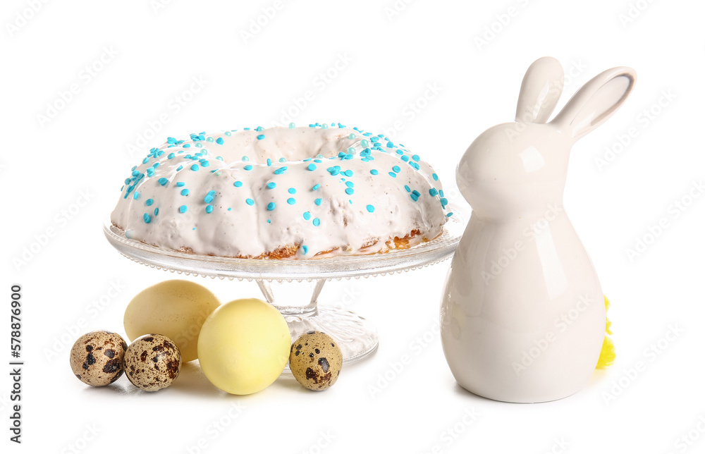 Dessert stand with tasty Easter cake, eggs and ceramic bunny isolated on white background