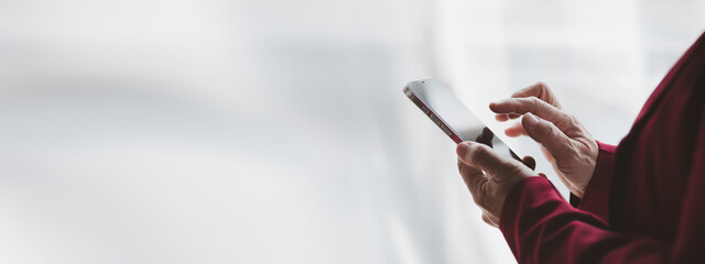 Senior business woman is in the office room and using the phone, she is the senior executive of the company, business operations by senior senior women, senior management work.