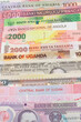 A collection of African currencies with a 1 American dollar bank note sitting on top