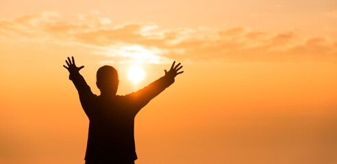 Wall Mural - Silhouette of woman raising her hand praying spirituality and religion, banner and copy space of female worship to god. Christianity religion concept.Christians person are pray humility humble to god.