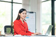 © ND STOCK - Portrait of pretty cheerful girl smiling while working on laptop in office
