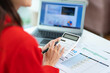 © ND STOCK - Portrait of asian business woman paying bills online with laptop in office. Beautiful girl with computer and checkbook, happy paying bills. Startup business financial calculate account concept