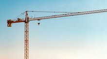 Construction Crane In Front Of Cloudless Sunny Blue Sky