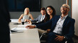 © Jacob Lund - Team of happy business people hearing a presentation in an office meeting