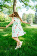 © Cavan Images - A young girl twirls in a circle outside