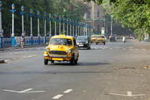 Vintage Yellow Taxi On The Roads Of Kolkata, India
