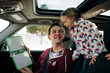© Cavan Images - father and daughter drawing in the car smiling having fun