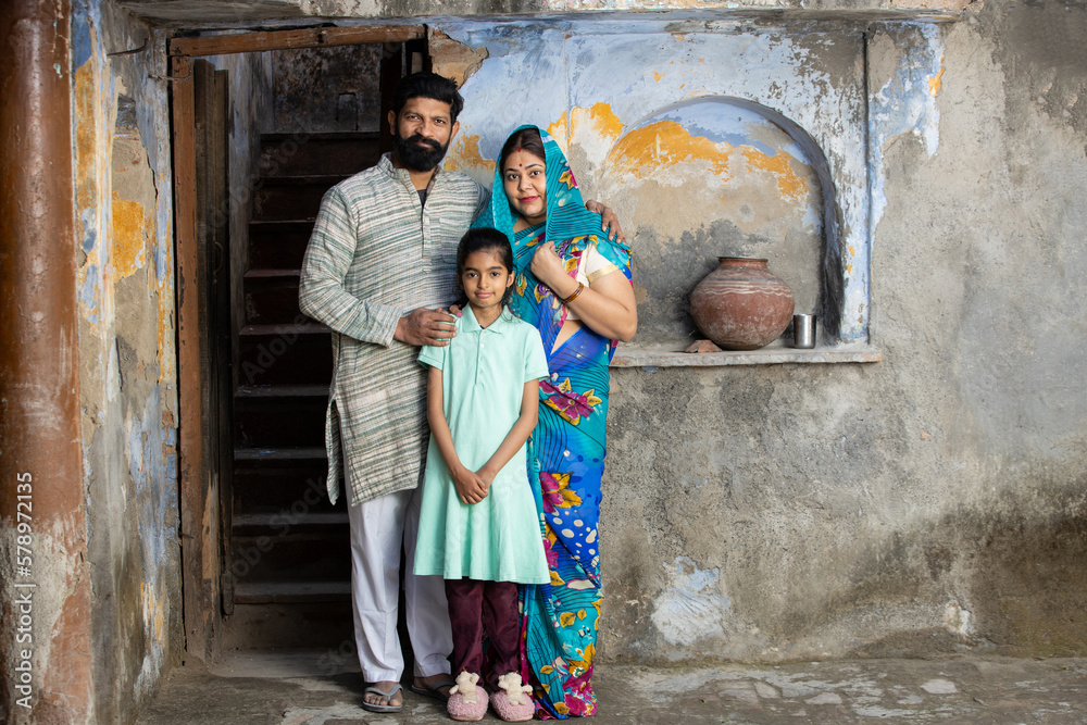 Young Rural indian parents with daughter, Happy young family looking at ...