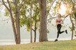 Asian woman jogging outdoors before sunset