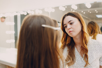 Beautiful young woman applying makeup beauty visage brush.